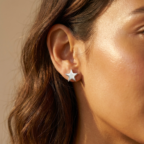 Silver star stud earrings worn close-up — waterproof by Pippa & Co