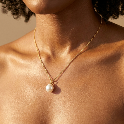 Gold pearl pendant necklace worn close-up — waterproof by Pippa & Co