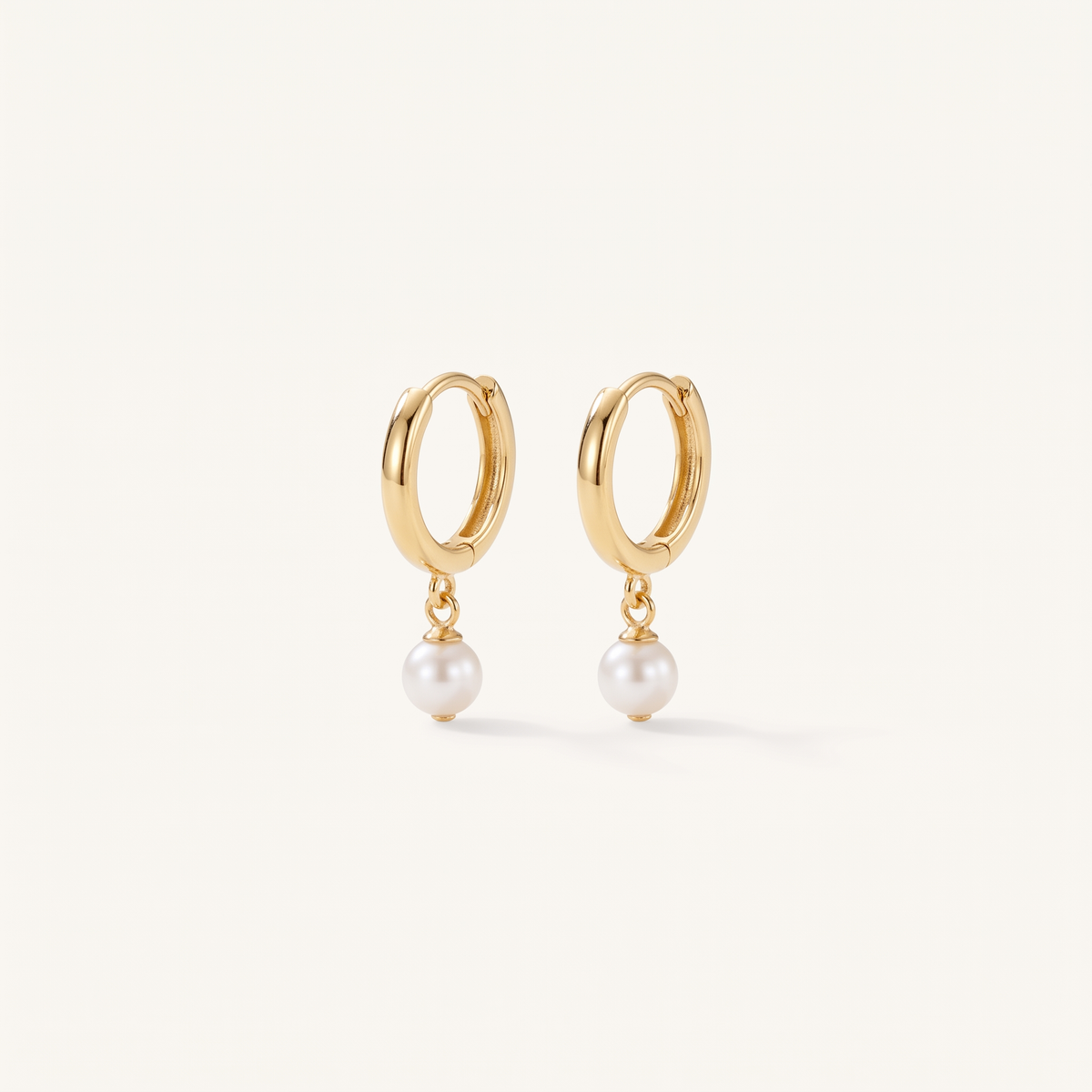 Gold Pearl Huggie Hoops product studio shot