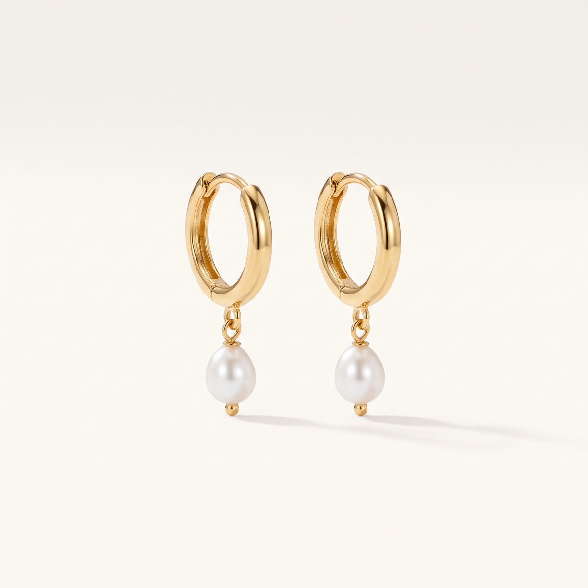 Gold Pearl Drop Huggie Hoops product studio shot