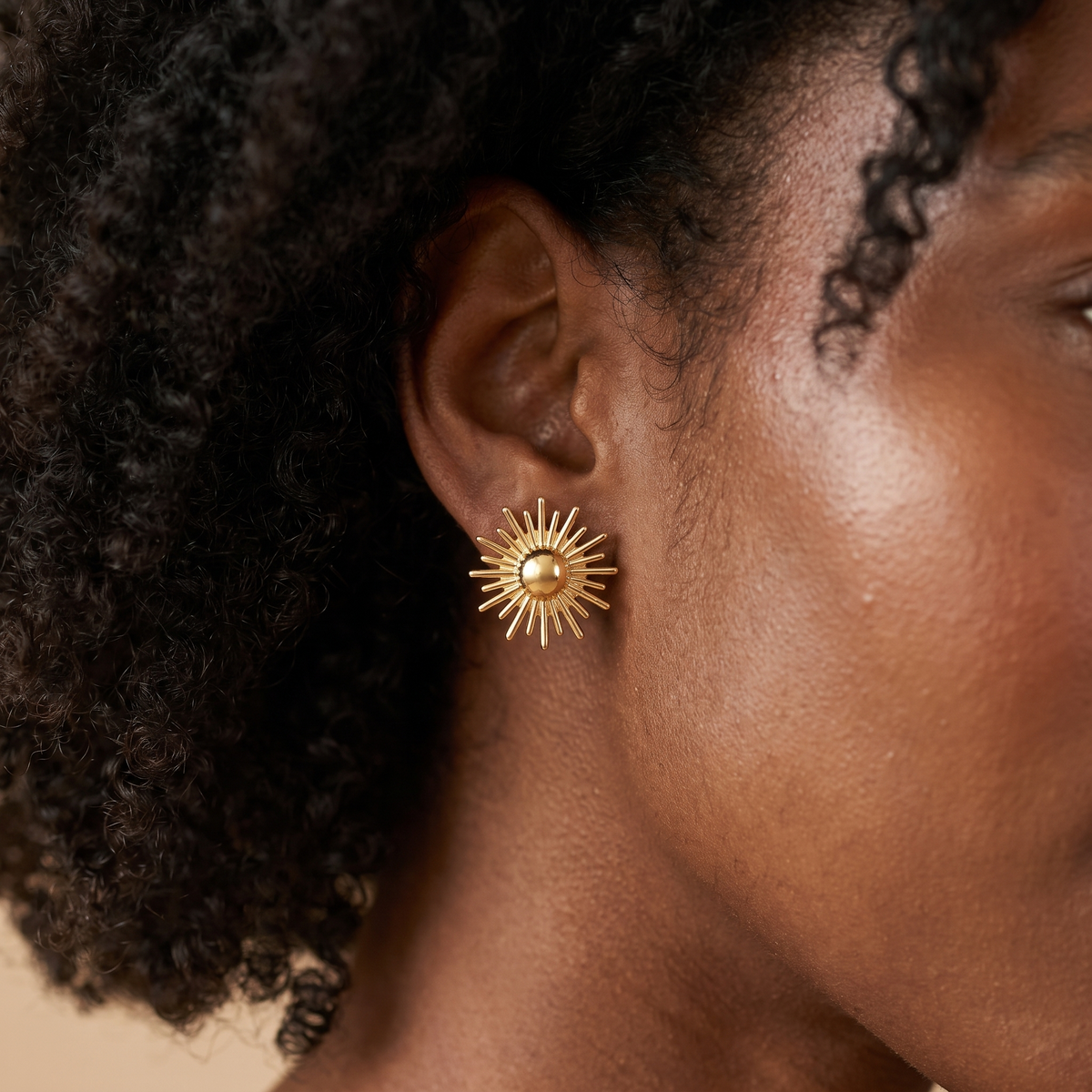 Gold Sun Stud Earrings worn close-up