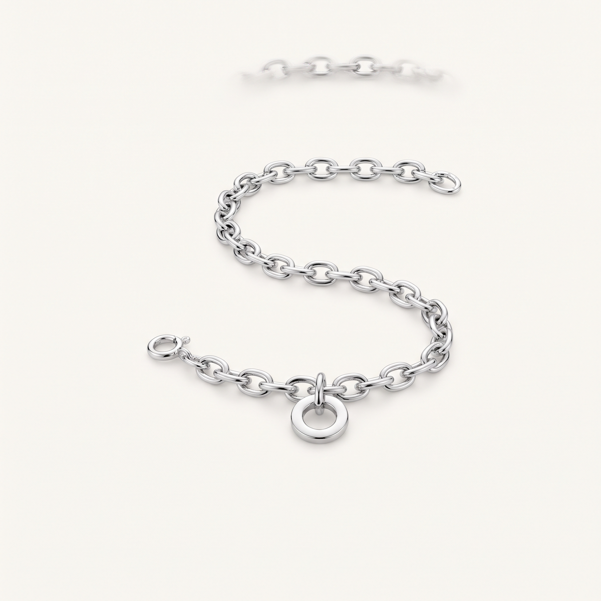 Silver charm bracelet worn close-up