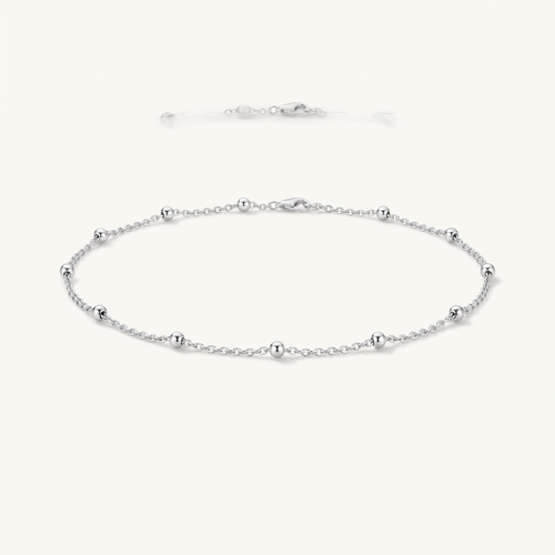 Silver beaded anklet worn close-up
