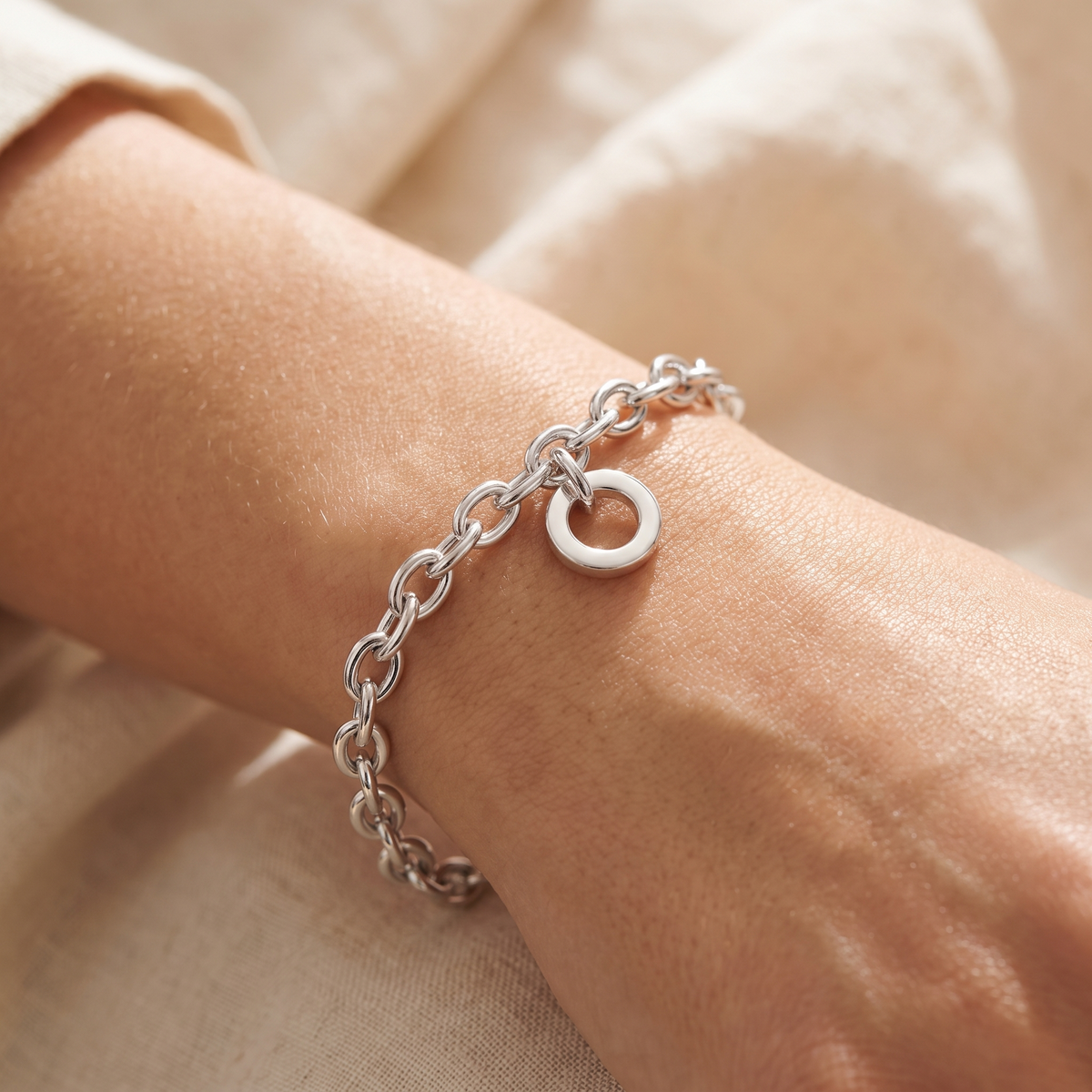 Silver charm bracelet studio product shot