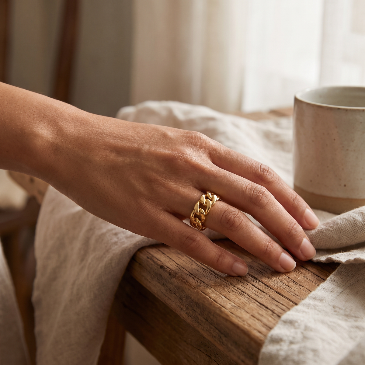 Gold chunky chain ring styled on hand