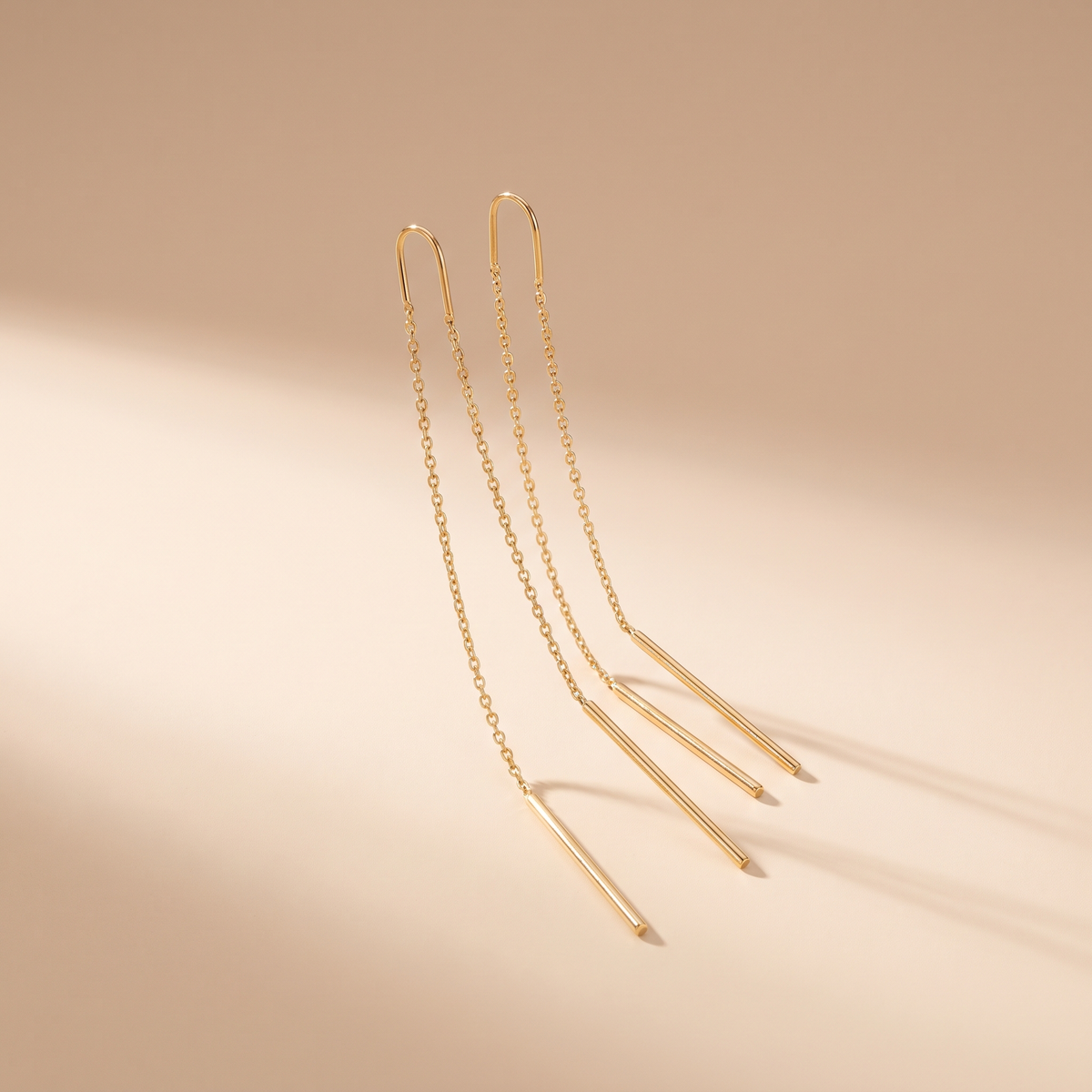 Gold threader earrings worn close-up